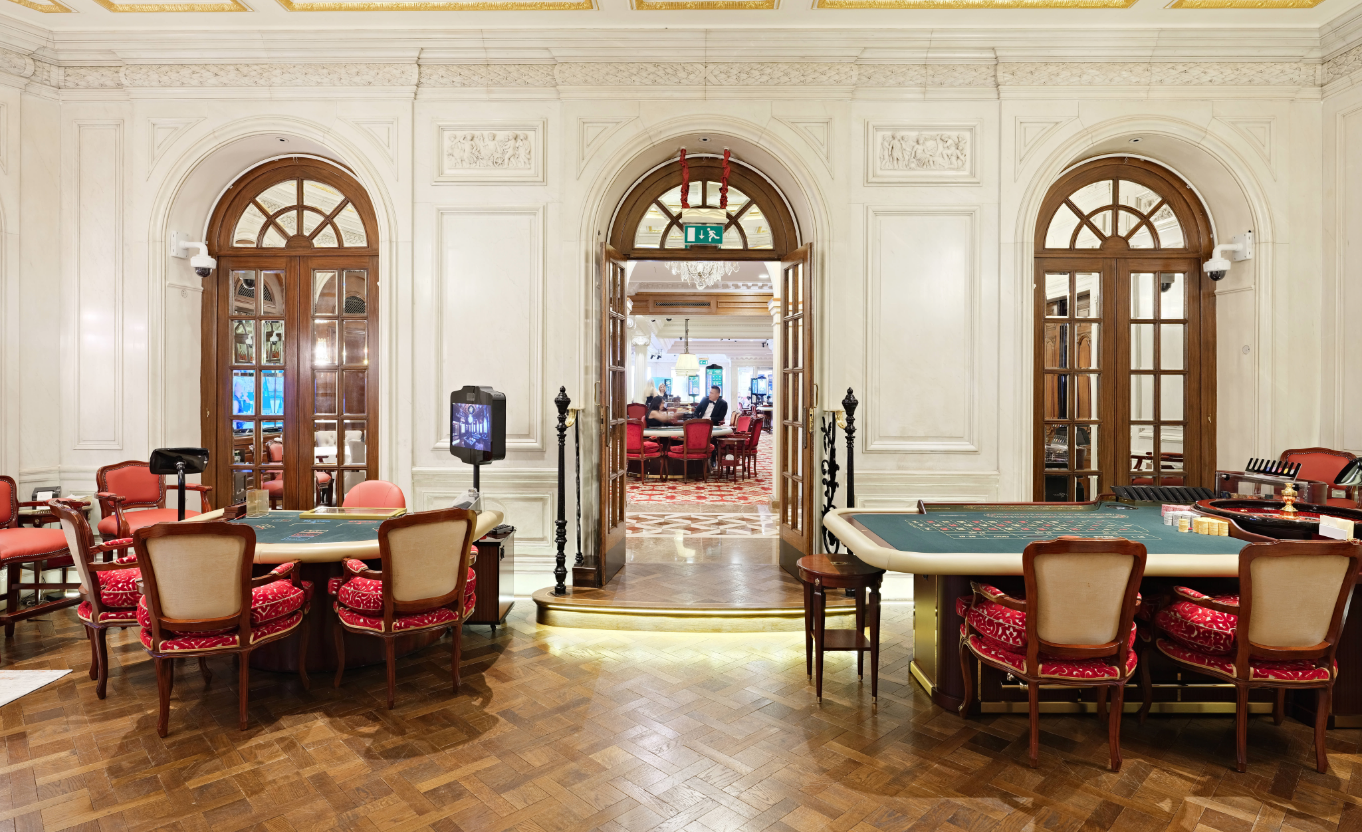 Elegant gaming room with roulette and card tables at Les Ambassadeurs Club